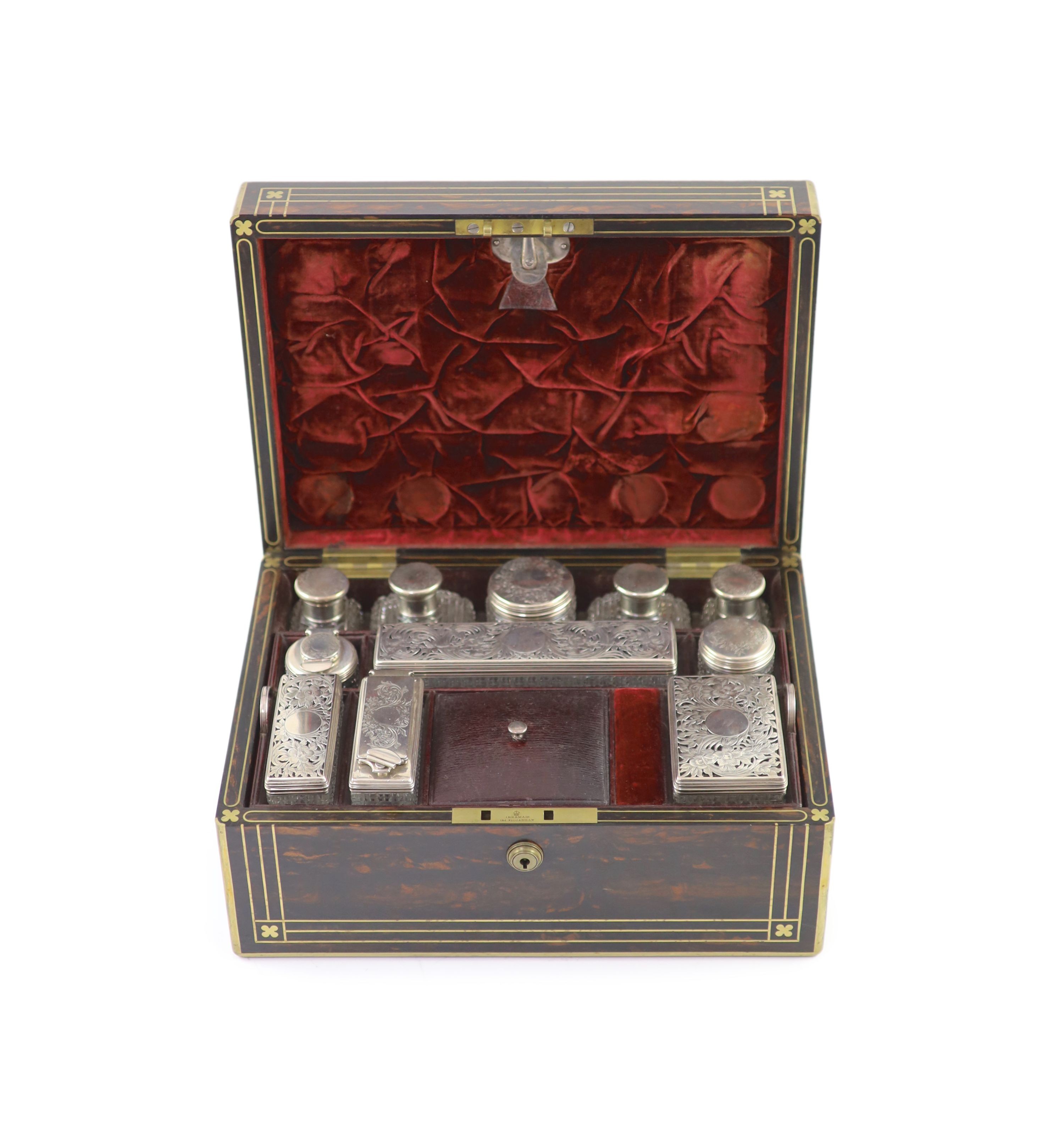 A good late William IV brass inlaid two handled coromandel wood travelling toilet set, containing eleven silver mounted glass jars etc.